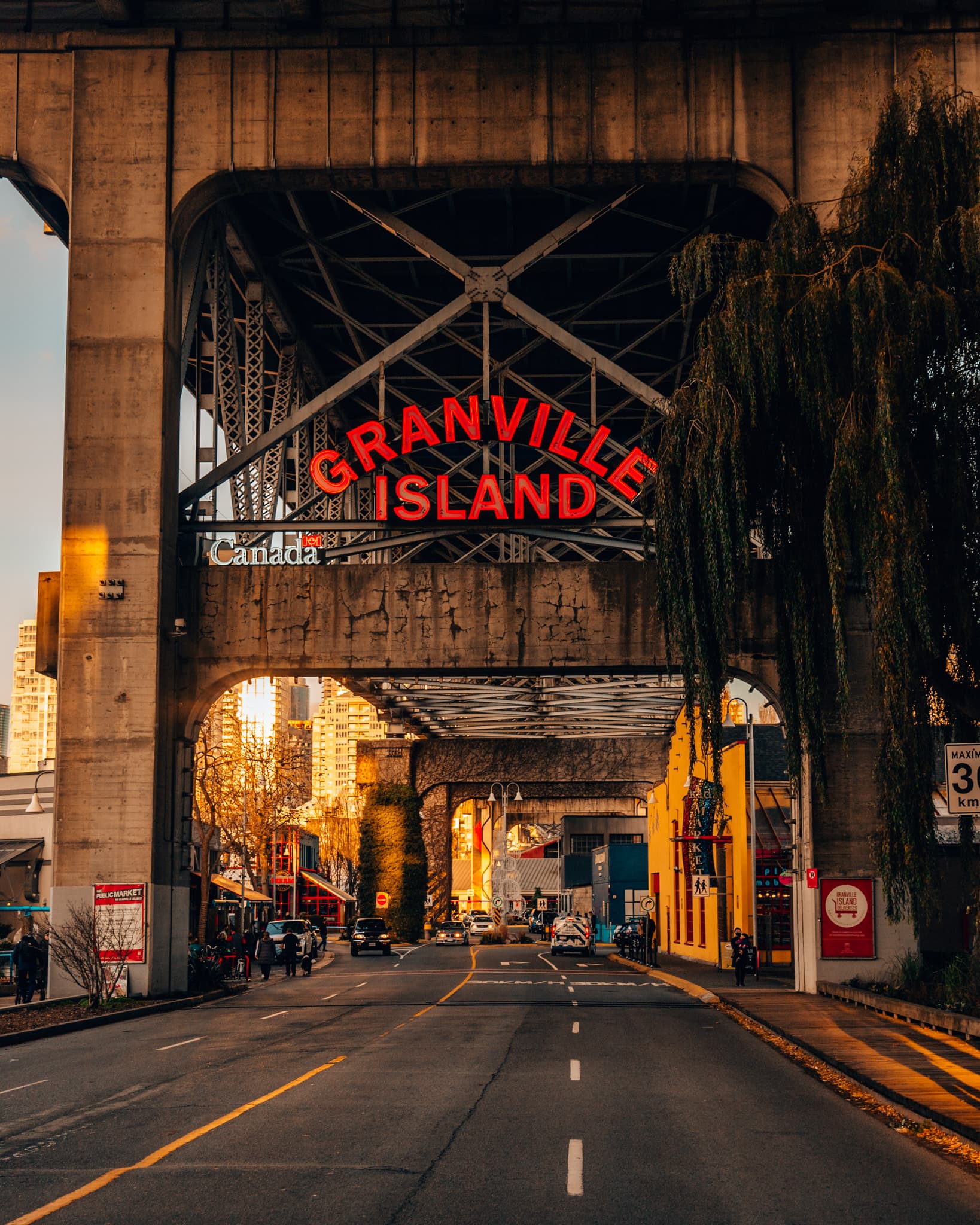 The red Granville Island entrance sign over False Creek